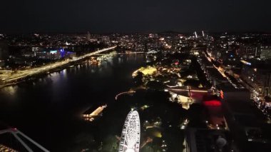 Queensland, Avustralya 'daki Brisbane CBD' nin 4K hava aracı görüntüleri, aydınlık gökdelenler, canlı şehir ışıkları ve köprüler boyunca akan trafik akışlarını gösteriyor. Görüntüler, Brisbane 'in ikonik Çarkıfeleği' ni yakalıyor. Güney Şeria 'nın manzaralı bölgesi.