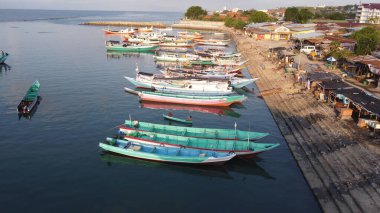 These boats, shaped by generations of fishermen, tell silent stories of early morning departures, bountiful catches, and the timeless rhythm of life by the water