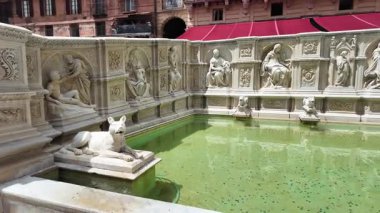 Siena Italy - May 21 2025. Fonte Gaia in Piazza del Campo with marble sculptures and water reflecting historic buildings 