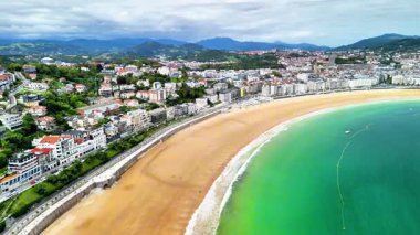 A breathtaking aerial view that showcases the everpicturesque beach along with a vibrant coastal city nearby
