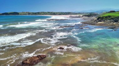 Nefes kesen okyanus manzarası dalgaları dramatik bir şekilde engebeli kayalara çarpıyor.