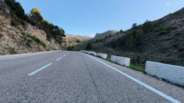 Dolambaçlı bir dağ yolunun nefes kesici güzelliğini yakalayın. Tamamen büyüleyici doğa manzarasıyla çevrili.