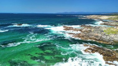 Bir hava görüntüsü dalgaların engebeli kayalara çarpmasını güzel bir şekilde yakalar.