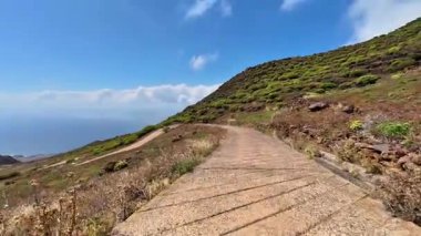 Sersemletici bir dağ yolunu keşfetmek için canlı yeşillik ve nefes kesici manzaralarla dolu bir maceraya atılın.