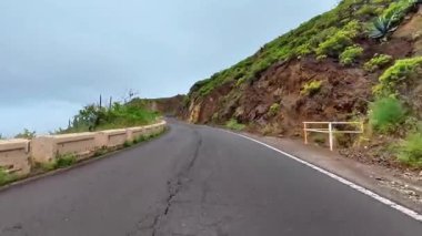 Sersemletici derecede güzel, dolambaçlı bir yol, bulutlu bir günde yemyeşil bir dağ zeminine güzel bir şekilde kurulmuş.