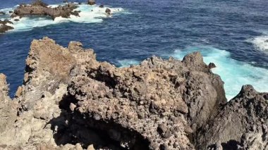 Deniz kenarının nefes kesen manzarası inanılmaz engebeli kayalar ve çarpan okyanus dalgaları.