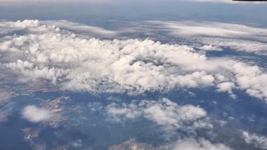 Uçuşun huzur veren güzelliğini bir uçağın penceresinden derin mavi gökyüzünde dans eden nefes kesici bulutlara bakarken hissedin.