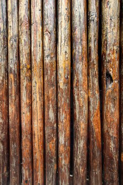 Vertical wooden wall background with visible cracks and distressed rustic planks. Ideal for abstract designs, vertical layouts, vintage concepts, and creative templates.