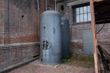 Çok eski endüstriyel makinelerde pas bozulması ve yüz yıllık mezarlığın yıpranmış kapıları (Pre Lachaise, Fransa).