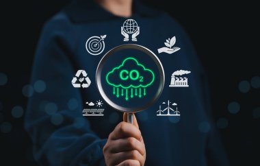 Karbondioksit salınımını azaltın. Karbon ayak izi farkındalığını temsil eden CO2 bulut sembolüne odaklanan büyüteç, net sıfır ve karbon nötr. iklim değişikliği, küresel ısınma, sera gazı,