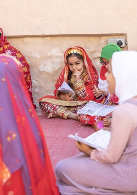 Nizwa, Oman, 2nd December 2022: omani girls reciting a Holy Book clipart