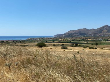 Otlaklar, dağlar, deniz ve Gkeada 'nın en güney sahilinden temiz gökyüzü manzarası. Gökçeada Imbros Adası, Türkiye Adaları 'ndan manzara