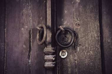 Old rusty lock hook and modern door lock on wooden door. Door of old rustic wood with padlock vintage concept.
