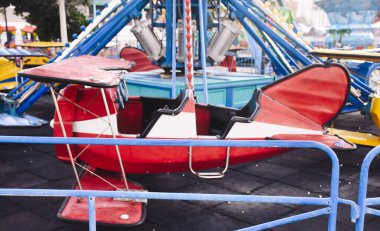 A small plane spinning on the carousel at amusement park