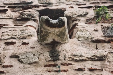 Drainage channel built into the stone wall of a castle from the Ottoman period.Medieval era water flow drainage channel in an old castle wall