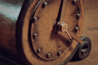 Close up of vintage leather alarm clock. Close-up of alarm clock mechanism, hour and minute hands