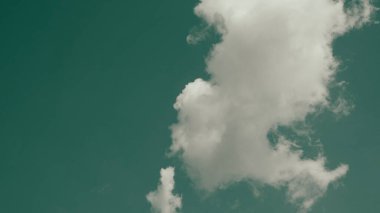 A big vertical white cloud in a single cluster in a clear sky. Cloud cluster can be used for graphic works and resource