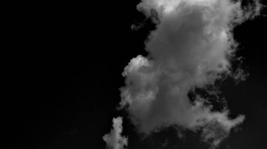 Masses of clouds hanging in dark bacground. smoke in dark