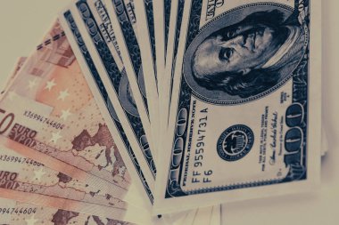 Dollars and euros lined up one after another 