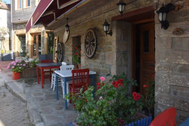 An Aegean restaurant with an old greek stone house in the center of Gkeada. June 14, 2022