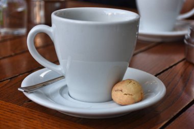  a cup of espresso  coffee served with a cookie on wooden table. Vintage, romantic coffee concept