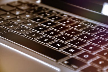 Extreme close up of black and gray  modern laptop keyboard