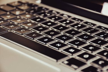 Extreme close up of black and gray  modern laptop keyboard