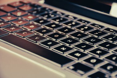 Extreme close up of black and gray  modern laptop keyboard