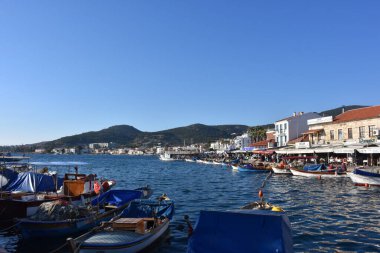 Izmir, Foca Turkey. 07.06.2021 Streets leading to the sea, fishing boats, restaurants, and people walking in Old Foa. Foca is a famous town on the Aegean coast