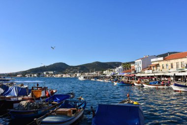 Izmir, Foca Turkey. 07.06.2021 Streets leading to the sea, fishing boats, restaurants, and nomadic people walking in Old Foa. Foca is a famous town on the Aegean coast