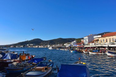 Izmir, Foca Turkey. 07.06.2021 Streets leading to the sea, fishing boats, restaurants, and nomadic people walking in Old Foa. Foca is a famous town on the Aegean coast