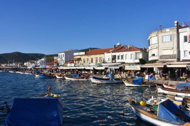 Izmir, Foca Turkey. 07.06.2021 Streets leading to the sea, fishing boats, restaurants, and nomadic people walking in Old Foa. Foca is a famous town on the Aegean coast