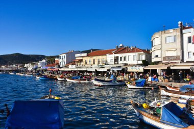 Izmir, Foca Turkey. 07.06.2021 Streets leading to the sea, fishing boats, restaurants, and nomadic people walking in Old Foa. Foca is a famous town on the Aegean coast