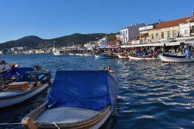 Izmir, Foca Turkey. 07.06.2021 Streets leading to the sea, fishing boats, restaurants, and nomadic people walking in Old Foa. Foca is a famous town on the Aegean coast