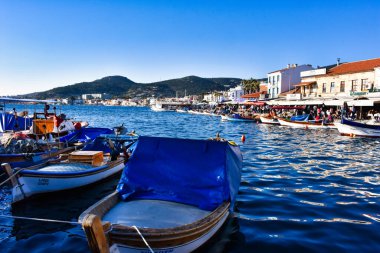 Izmir, Foca Turkey. 07.06.2021 Streets leading to the sea, fishing boats, restaurants, and nomadic people walking in Old Foa. Foca is a famous town on the Aegean coast