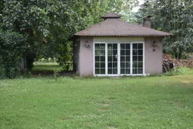 Outside view of a garden cottage in autumn. View of Small outbuilding in a garden. vintage autumn cards, wallpaper