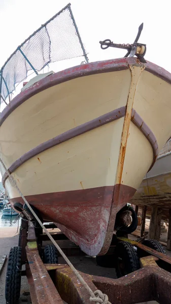 Fishing boat waiting for maintenance, to be repaired and painted at repair yard for boats, Gokceada, Imbros Turkey