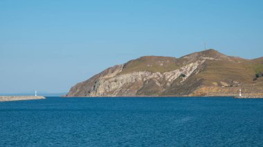 Sahil şeridi manzarası ve Gkeada Kuzu limanının sakin denizindeki deniz feneri. Imroz Adası Canakkale, Trkiye