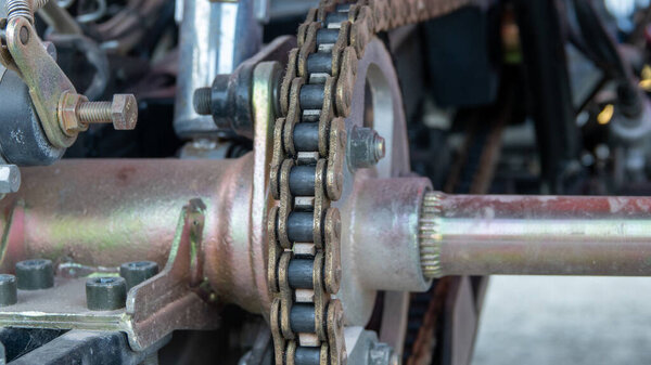ATV off road, on road all terrain vehicle engine details. Close up view of ATV hangers and motor chain system