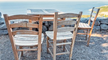 Gökçeada (Imbros) kıyı şeridi ve ahşap sandalyeli ve masalı şirin bir köy çay bahçesi manzarası. Tepeky köyü, Naralt-Pinarbasi bölgesi, Ege Türkiye