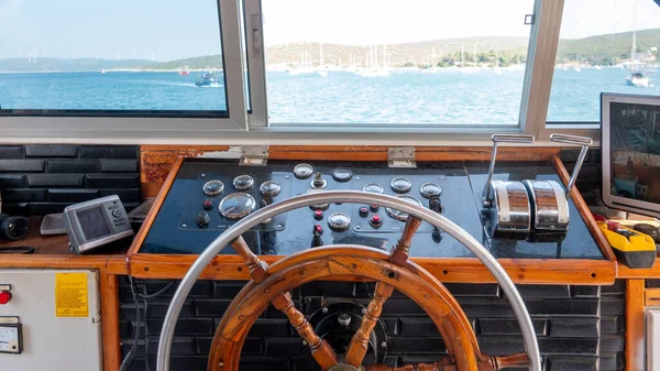 Steering wheel in the captain cabin of a big tour boat or ferry. Inside the captain\'s cabin. transportation and travel concept