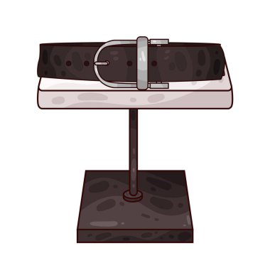 Masadaki kemer, işçiliğine, dokusuna ve toka tasarımına dikkat çekiyor. Deri, kumaş veya sentetik malzemeden yapılan kemerde dikiş, kabartma veya damgalama ayrıntıları yer alabilir.. 