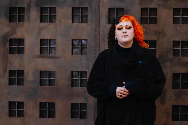 stock image Transgender girl with orange painted hair looking at camera.