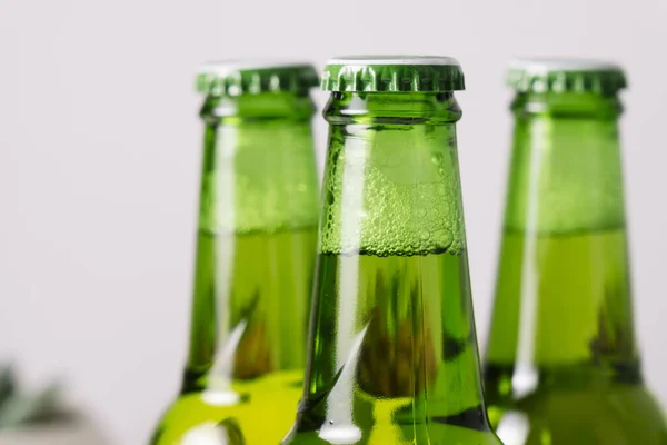 A green bottle of beer with the background out of focus.