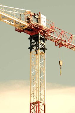 Black and white construction crane with blue sky. clipart