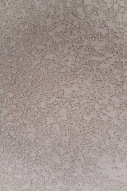 Duvar dokusu krem renginde düzleştirilmiş yardım şekilleri ile