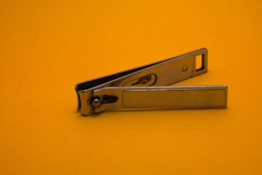 stainlessles nail cutter on yellow background