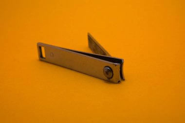 stainlessles nail cutter on yellow background