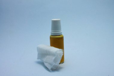 isolated bottle of wound medicine and cotton on white background