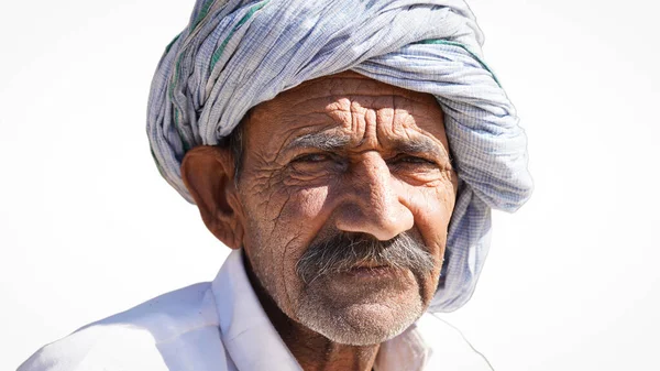 stock image Shallow focus of an old Indian man wearing a turban, Amazed old Indian man wearing white turban looking at camera.